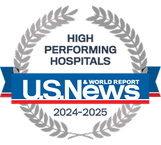 A silver U.S. News and World Report emblem of laurel leaves around text reading “High Performing Hospitals 2024-2025.”